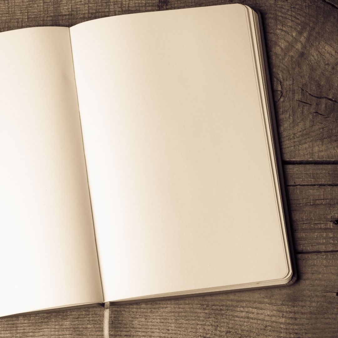 Open notebook on a wooden surface